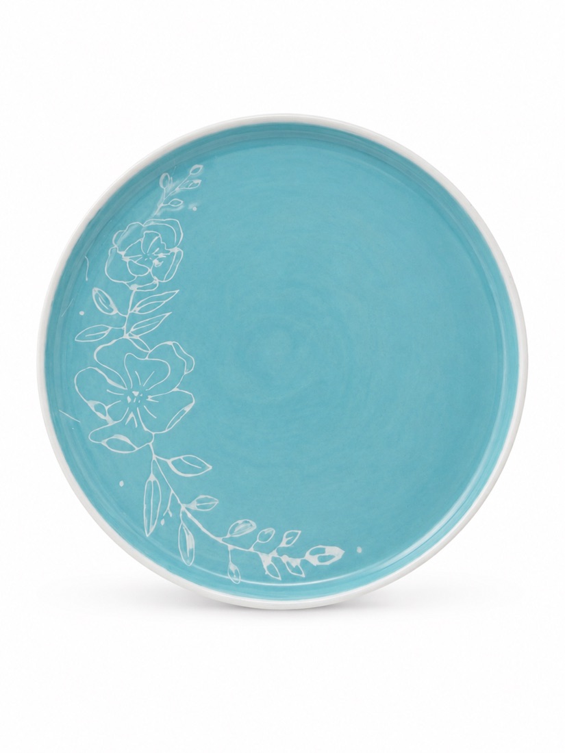 Türkiser Teller mit Blumenmotiv